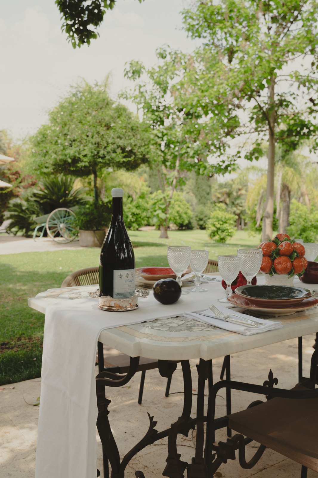 Outdoor dining table set in the garden at Villa Aranjaya in Sicily